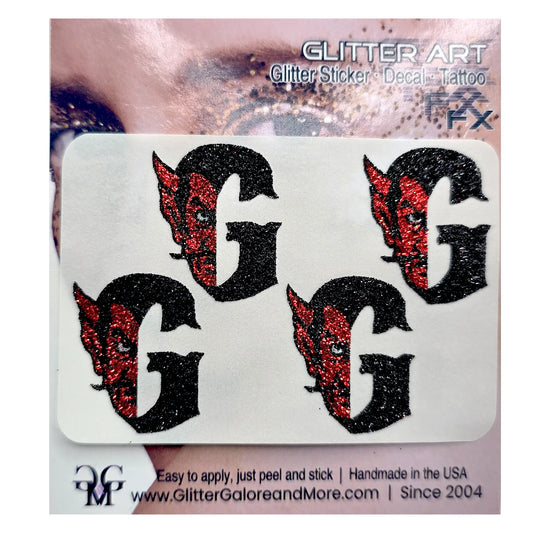 Four black glitter letter G decals with red glitter devil face details, presented on a white backing card labeled 'GLITTER ART'.