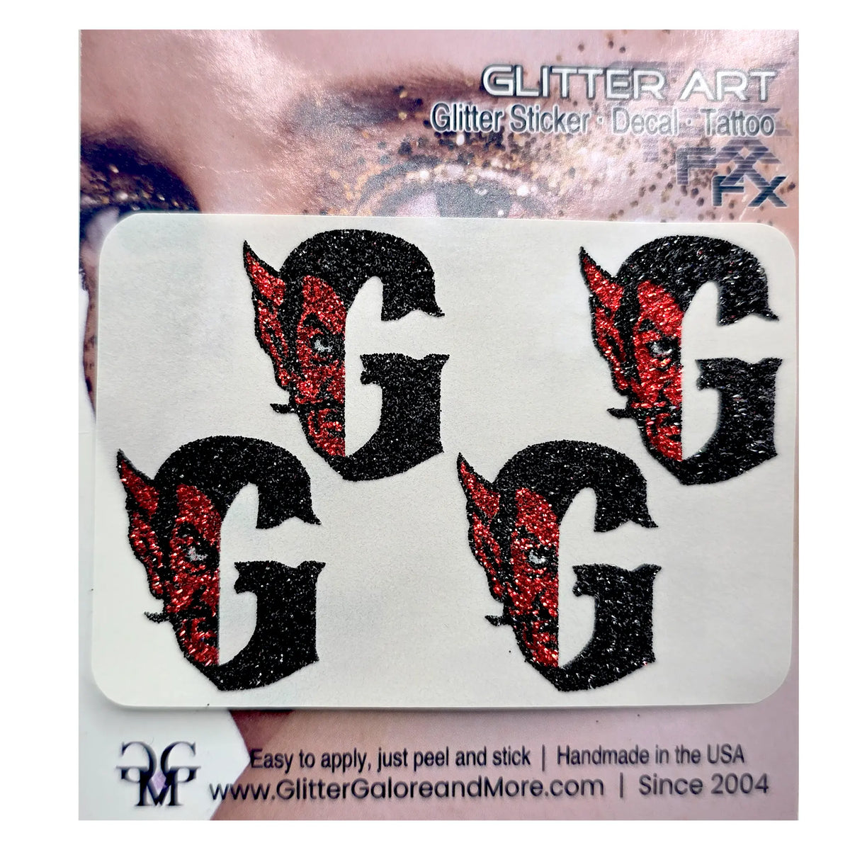 Four black glitter letter G decals with red glitter devil face details, presented on a white backing card labeled 'GLITTER ART'.